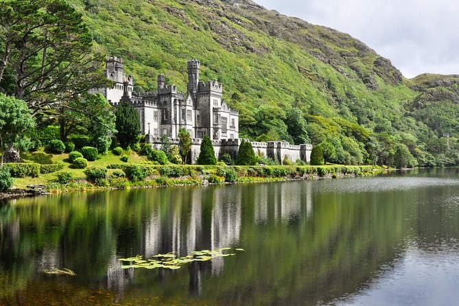 Kylemore Abbey from along the shore, with water lilies in the foreground