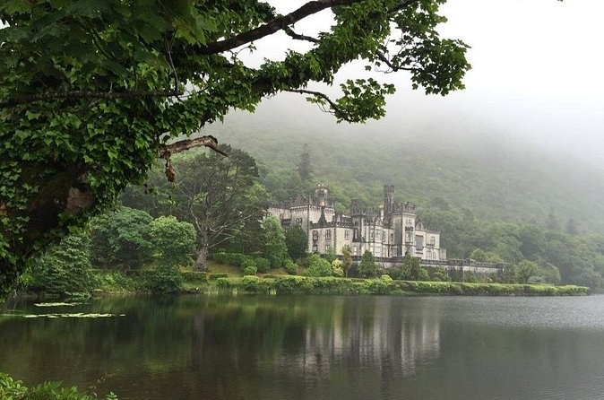 Low cloud over the mountain behind Kylemore Abbey, seen across the lough