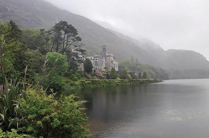 Kylemore Abbey on the far shore of the lough on a misty day