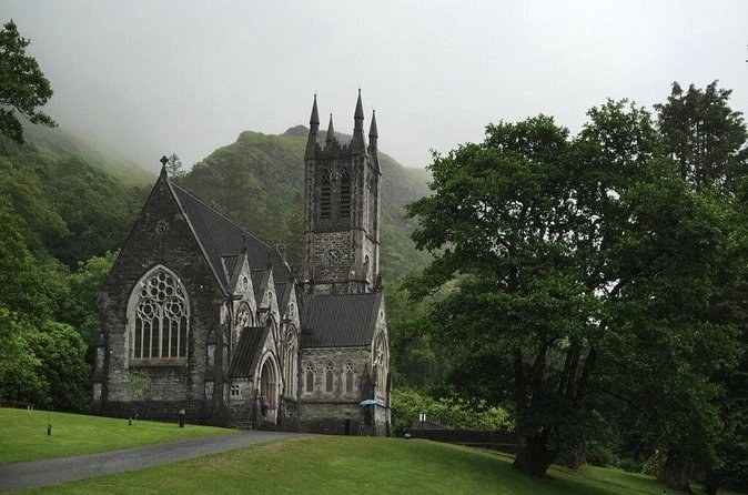 The Neo-Gothic Church at Kylemore, its tower and pinnacles against a misty hillside